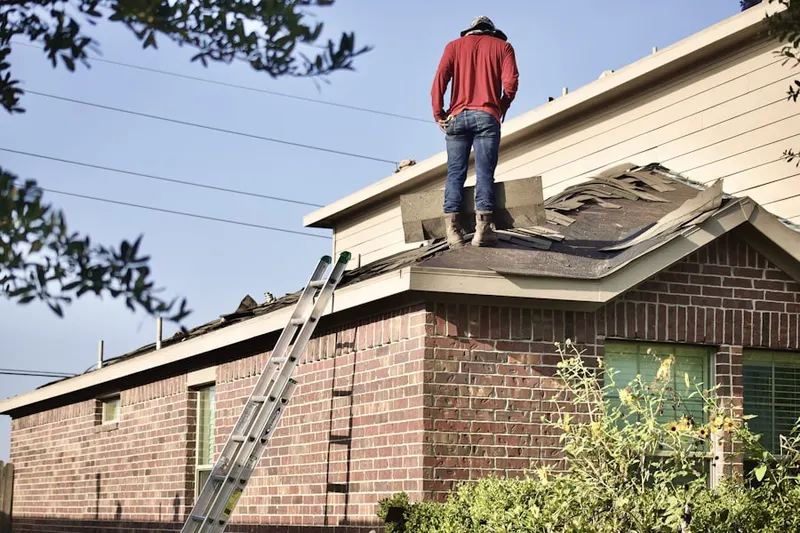 Professional roofer working on a residential roof in Sunsweet